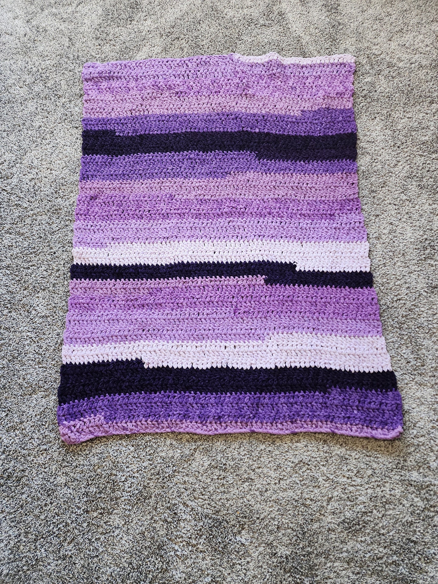 Crochet purple blanket.